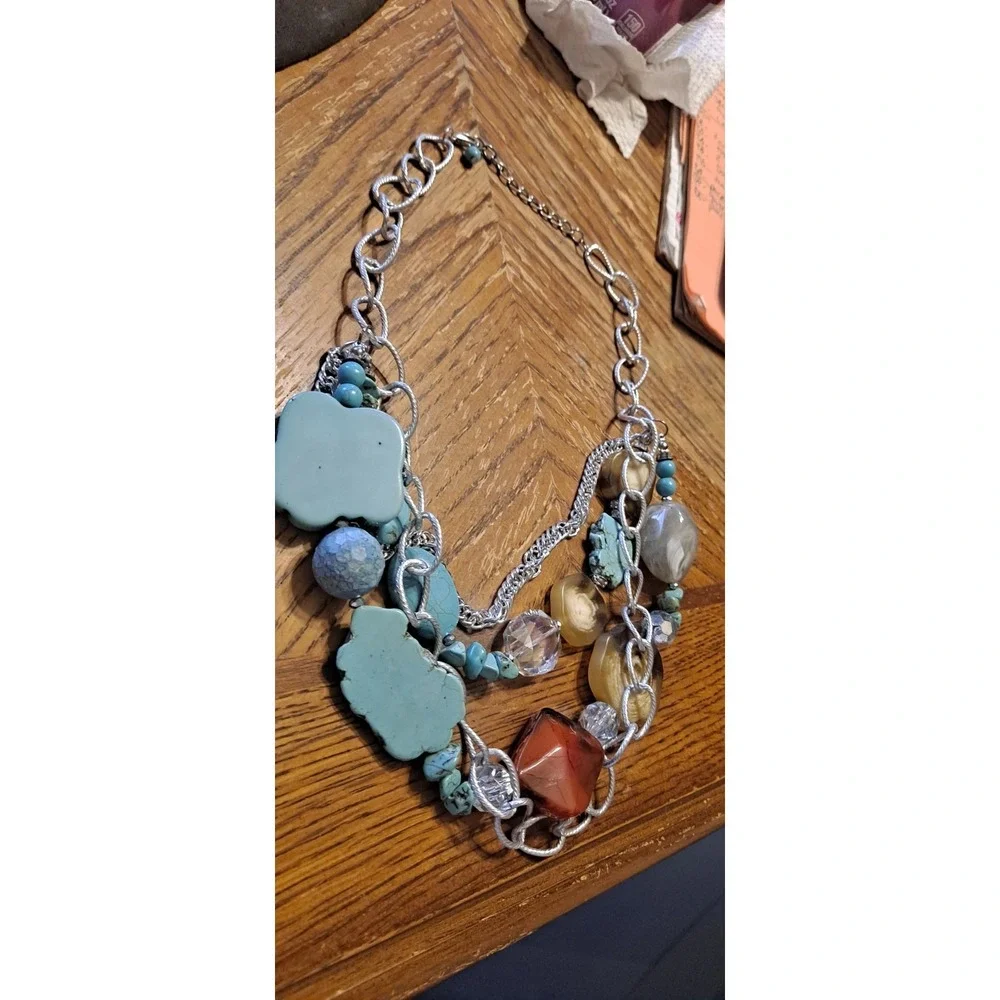 Southwestern-style statement piece featuring multiple strands of silver-toned...